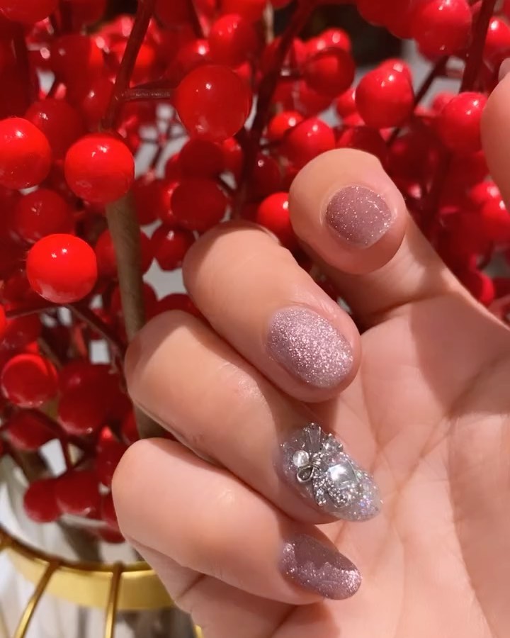 Pink glitter nails with silver butterfly gem